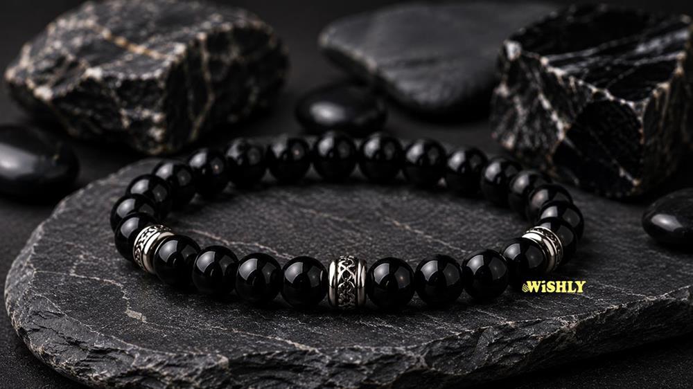 Black Onyx bracelet with polished black gemstone beads displayed alongside natural Black Onyx stones on a dark textured slate surface.